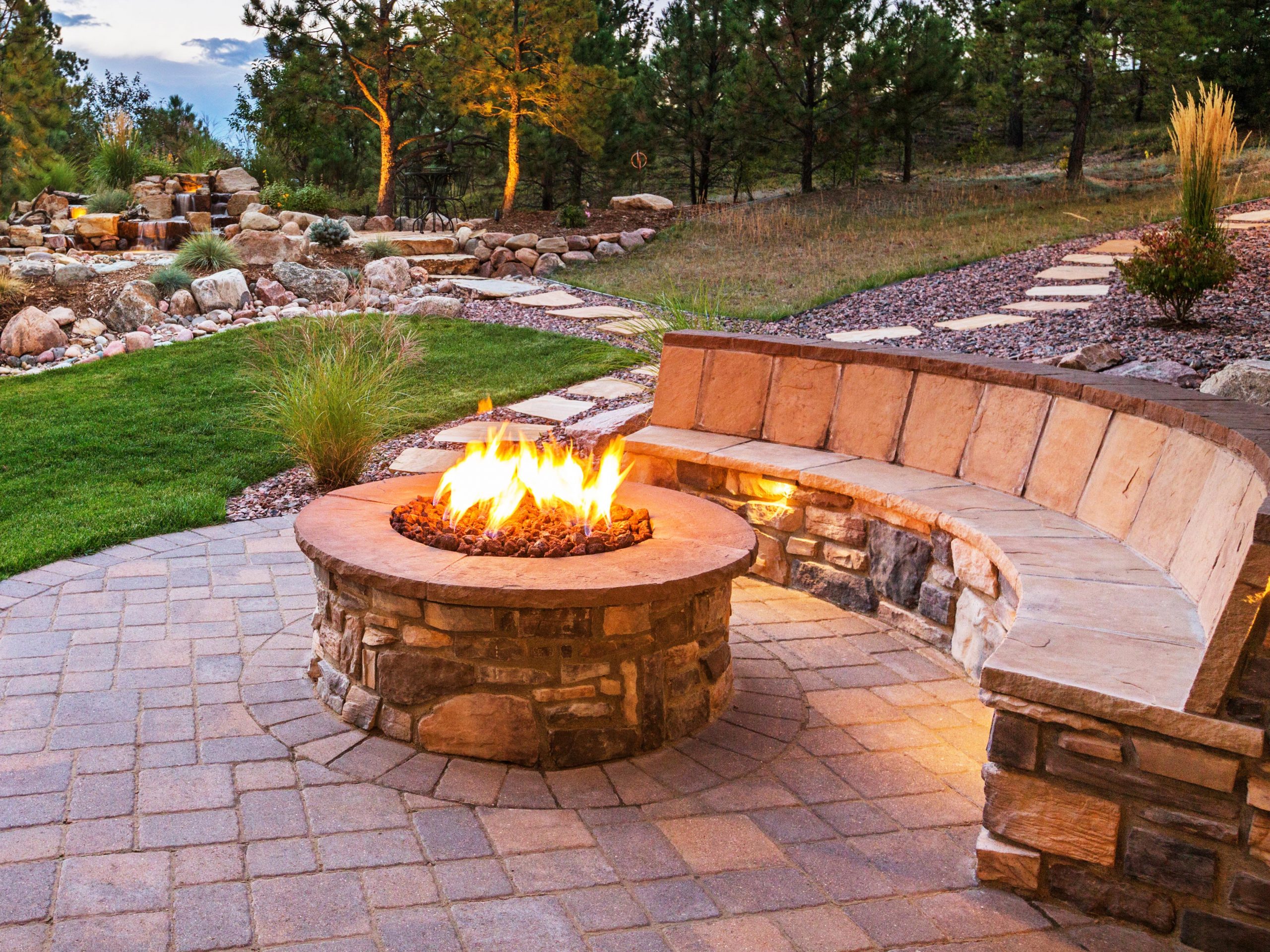 Outdoor fire pit next to built in bench